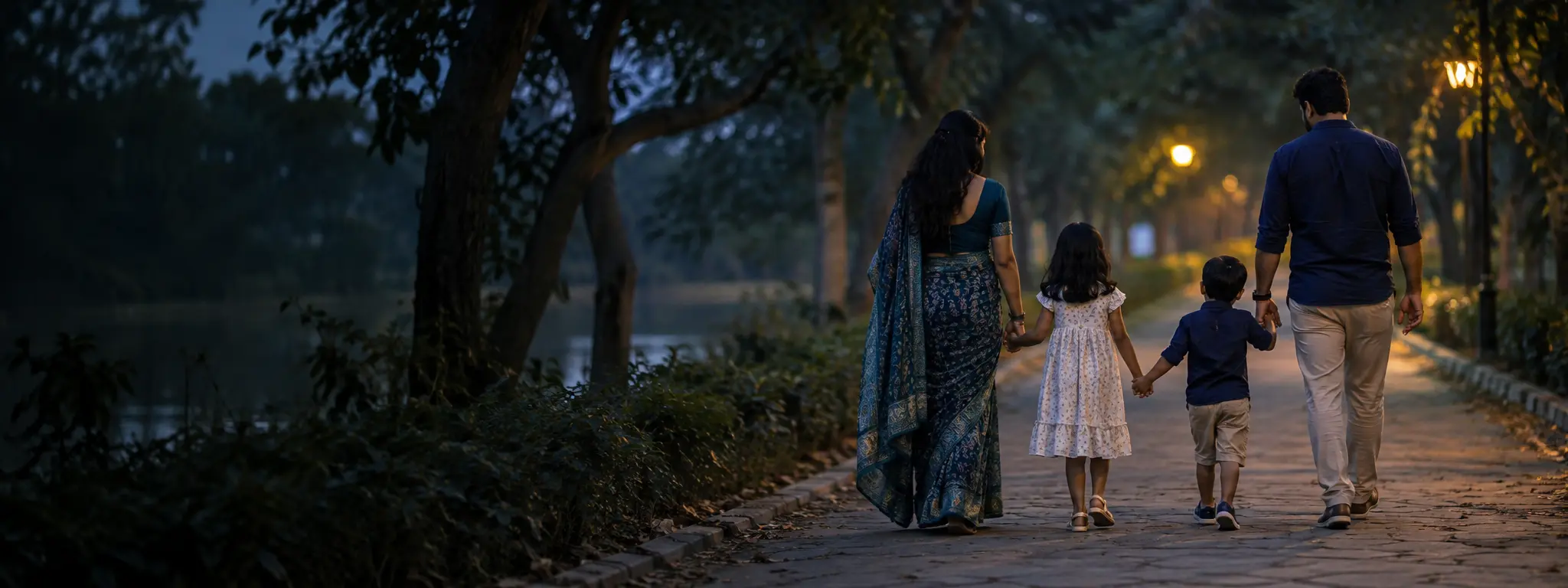 A family walking together along a quiet path at dusk